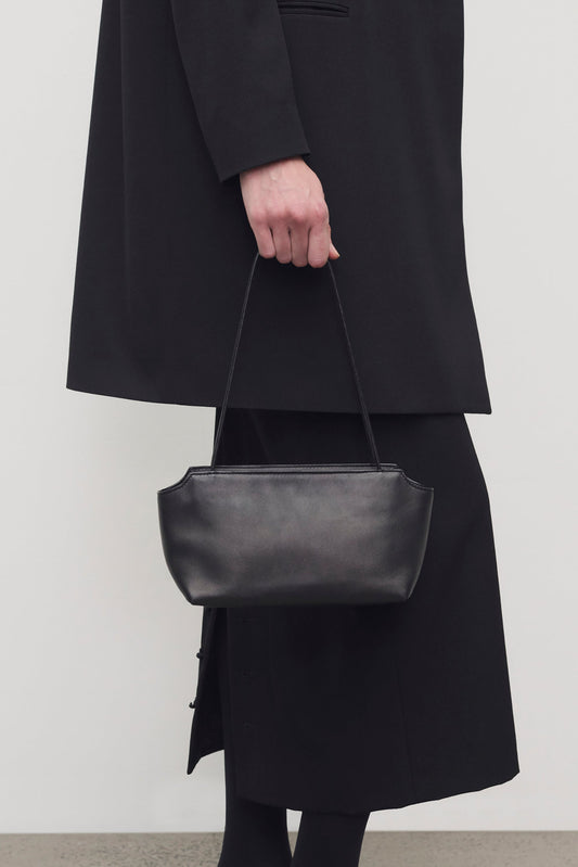 The Row Terrasse Leather To-Go Bag in Black, on model — The Quiet Edition