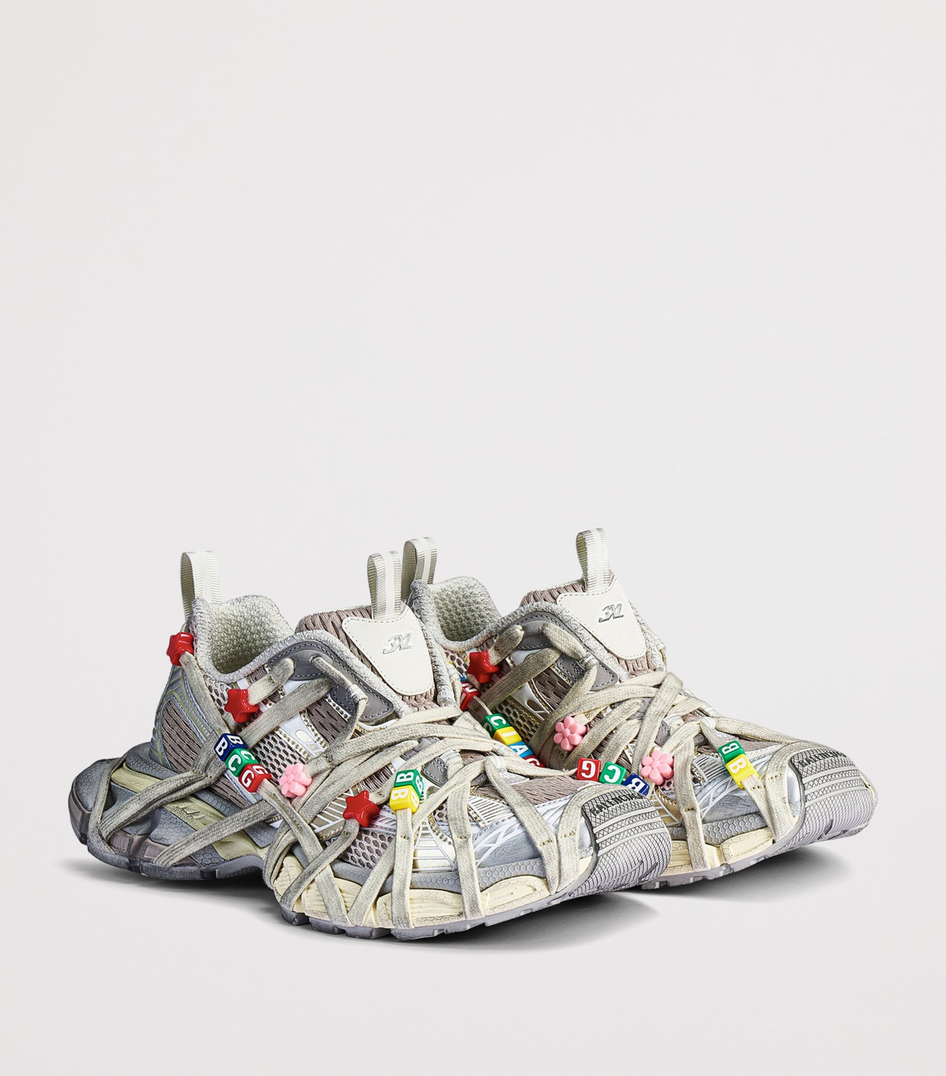 Balenciaga Distressed 3XL Extreme Lace Sneakers pair angled front view with letter bead lace charms