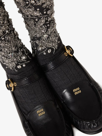 Miu Miu Leather Loafers with Strap in Black, worn detail with embellished socks — The Quiet Edition