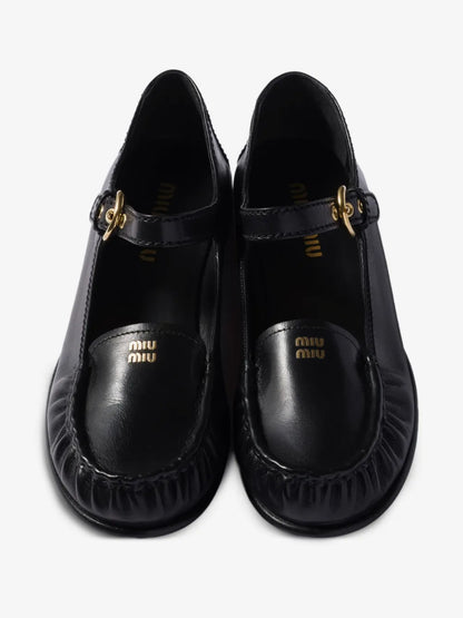 Miu Miu Leather Loafers with Strap in Black, top view of the pair — The Quiet Edition
