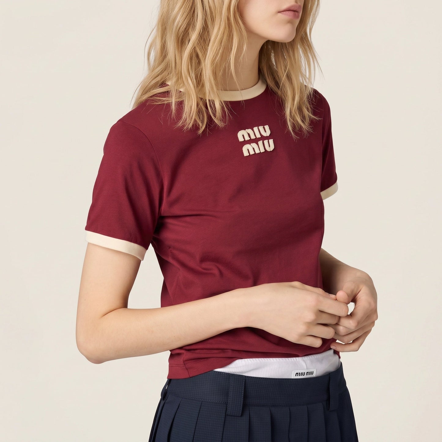 Miu Miu logo cotton t-shirt in burgundy, chest logo detail on model — The Quiet Edition
