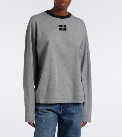 Miu Miu Oversized Cotton Jersey T-Shirt in grey on a model, front view showing the dropped shoulders