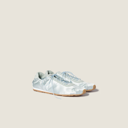 Miu Miu Plume satin sneaker in powder blue, angle view — The Quiet Edition