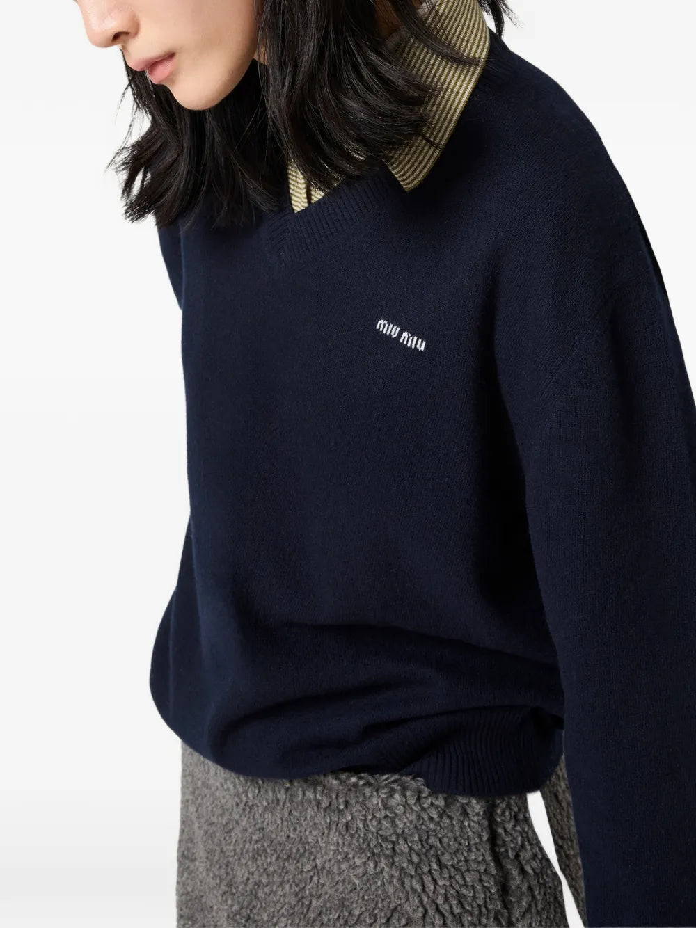 Miu Miu Wool and Cashmere Sweater in blue on a model, angled view of the V-neck and striped collar