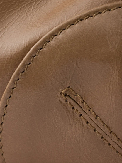 Prada Bonnie handbag detail of glossy tan calf leather with contrast stitching along the base seam