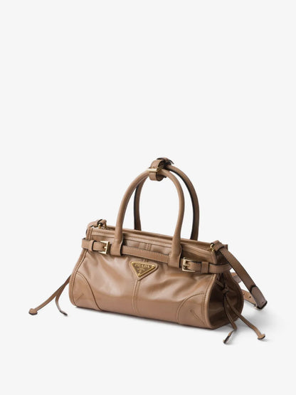 Prada Bonnie mini handbag in tan leather, angled view with detachable shoulder strap and side tassel