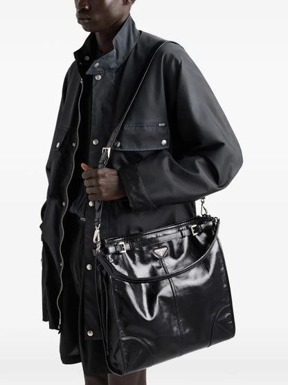 Prada Bonnie Leather Shoulder Bag in Black, worn on the shoulder view — The Quiet Edition