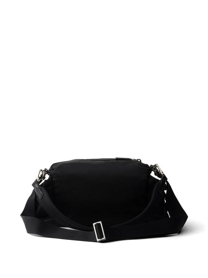Prada Explore Re-Nylon hobo bag in black, back view with adjustable strap — The Quiet Edition