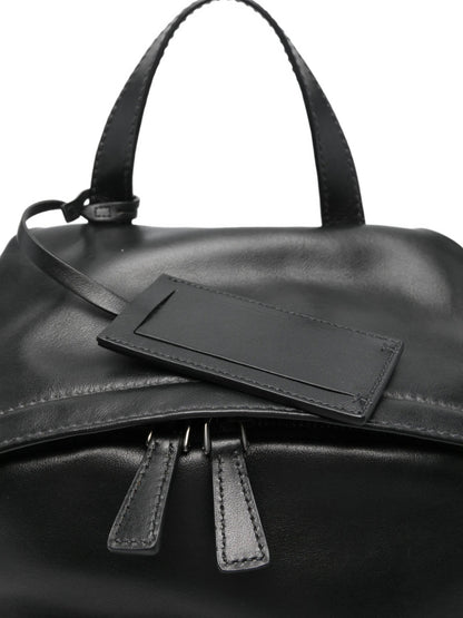 Prada leather backpack in black, top handle and pocket detail — The Quiet Edition