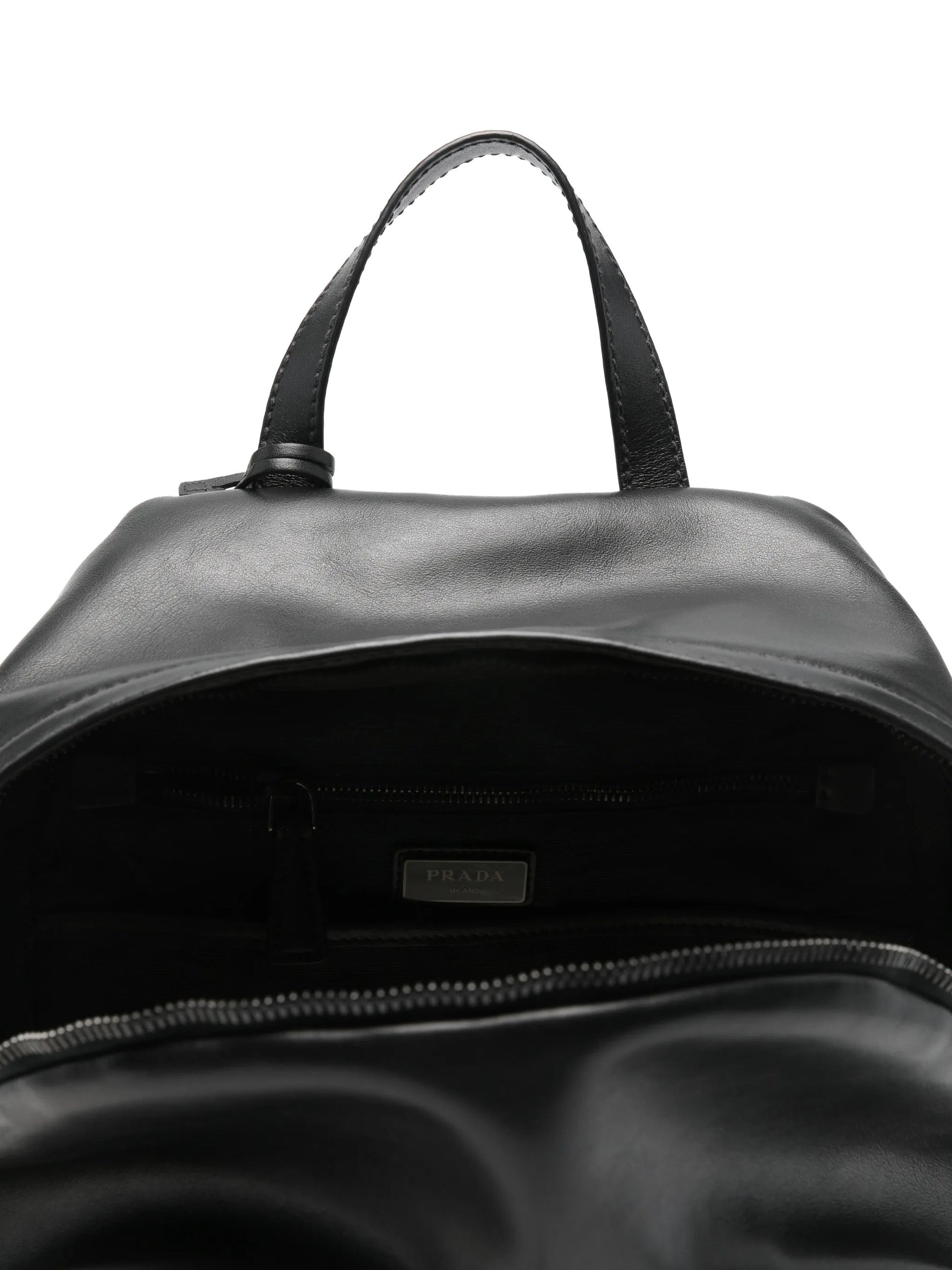 Prada leather backpack in black, interior with Prada Milano label — The Quiet Edition