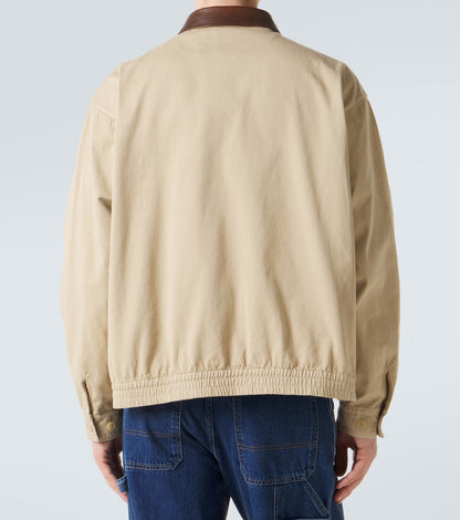 Prada Leather-Trimmed Cotton Blouson Jacket in beige, worn back view — The Quiet Edition