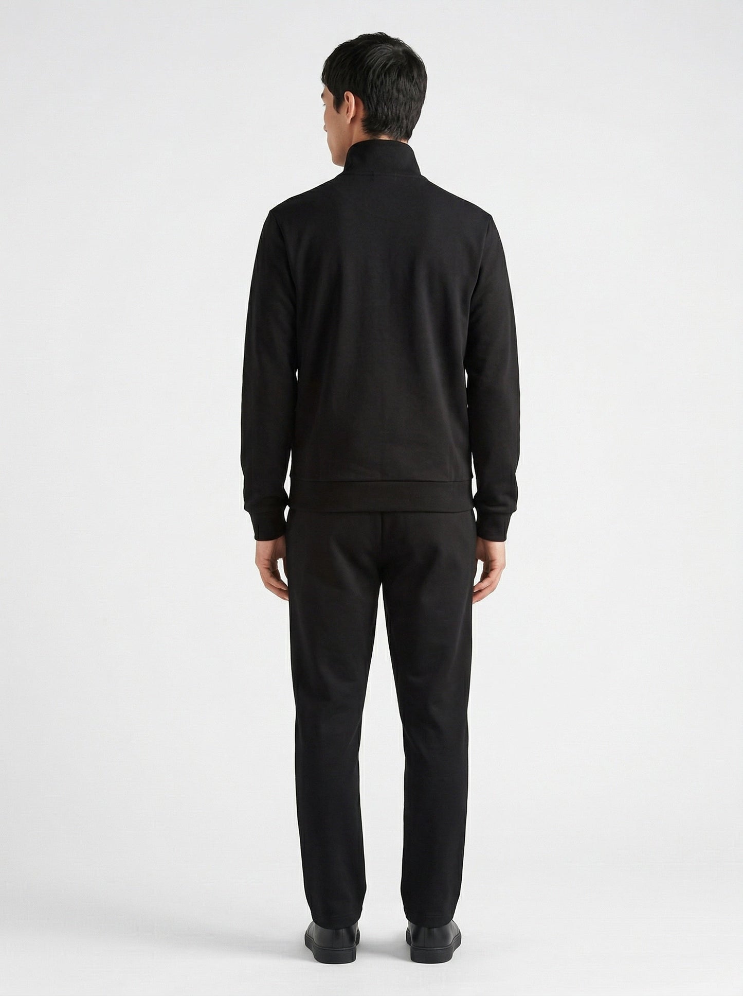Prada logo patch zip cardigan in black, model back — The Quiet Edition