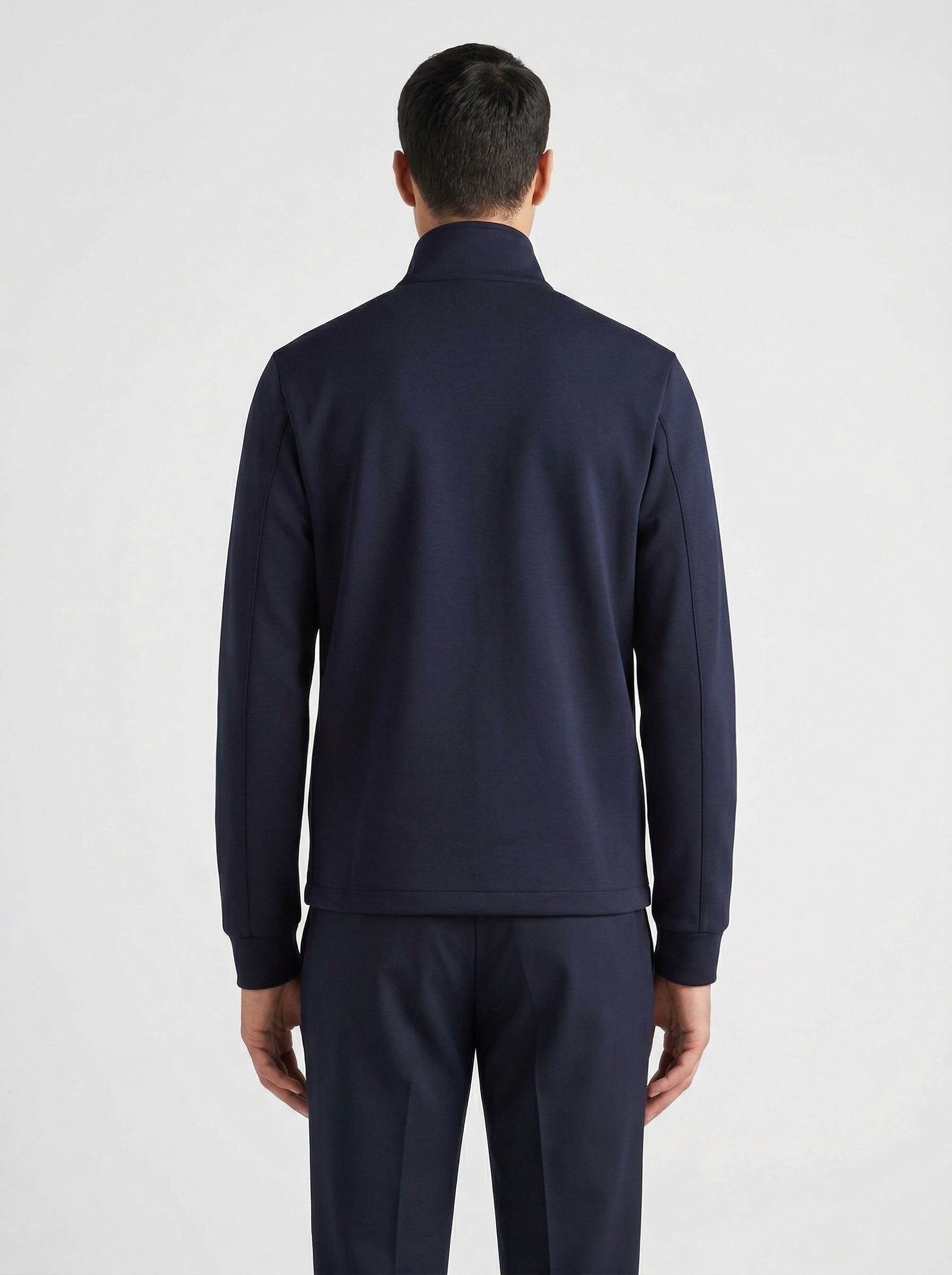 Prada logo patch zip cardigan in navy, model back — The Quiet Edition