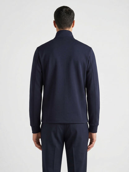 Prada logo patch zip cardigan in navy, model back — The Quiet Edition