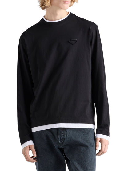 Prada Long-Sleeved Cotton T-Shirt in black worn by a male model with dark jeans, white cuffs showing