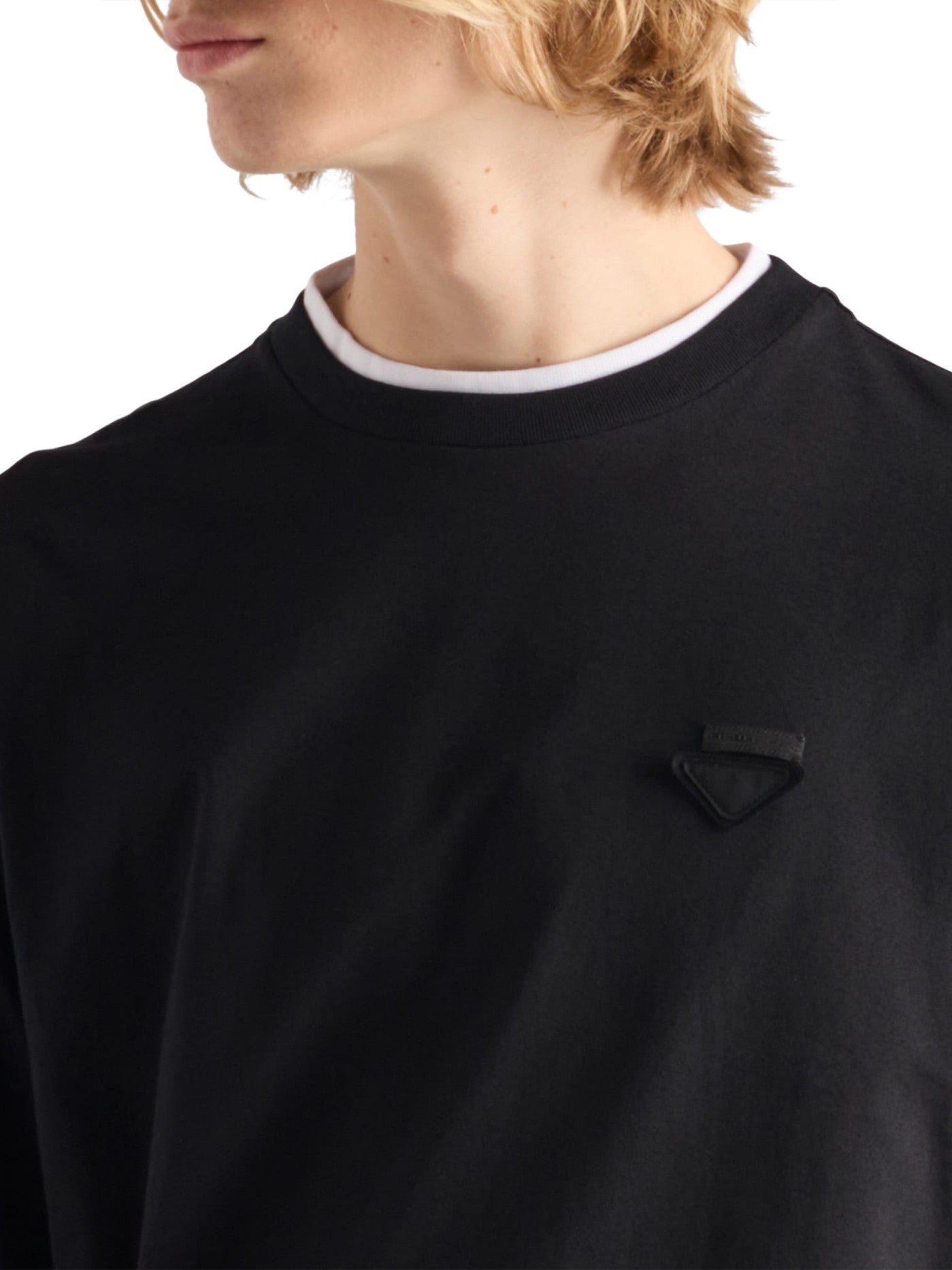 Prada Long-Sleeved Cotton T-Shirt in black, close-up of white collar trim and triangle logo plaque