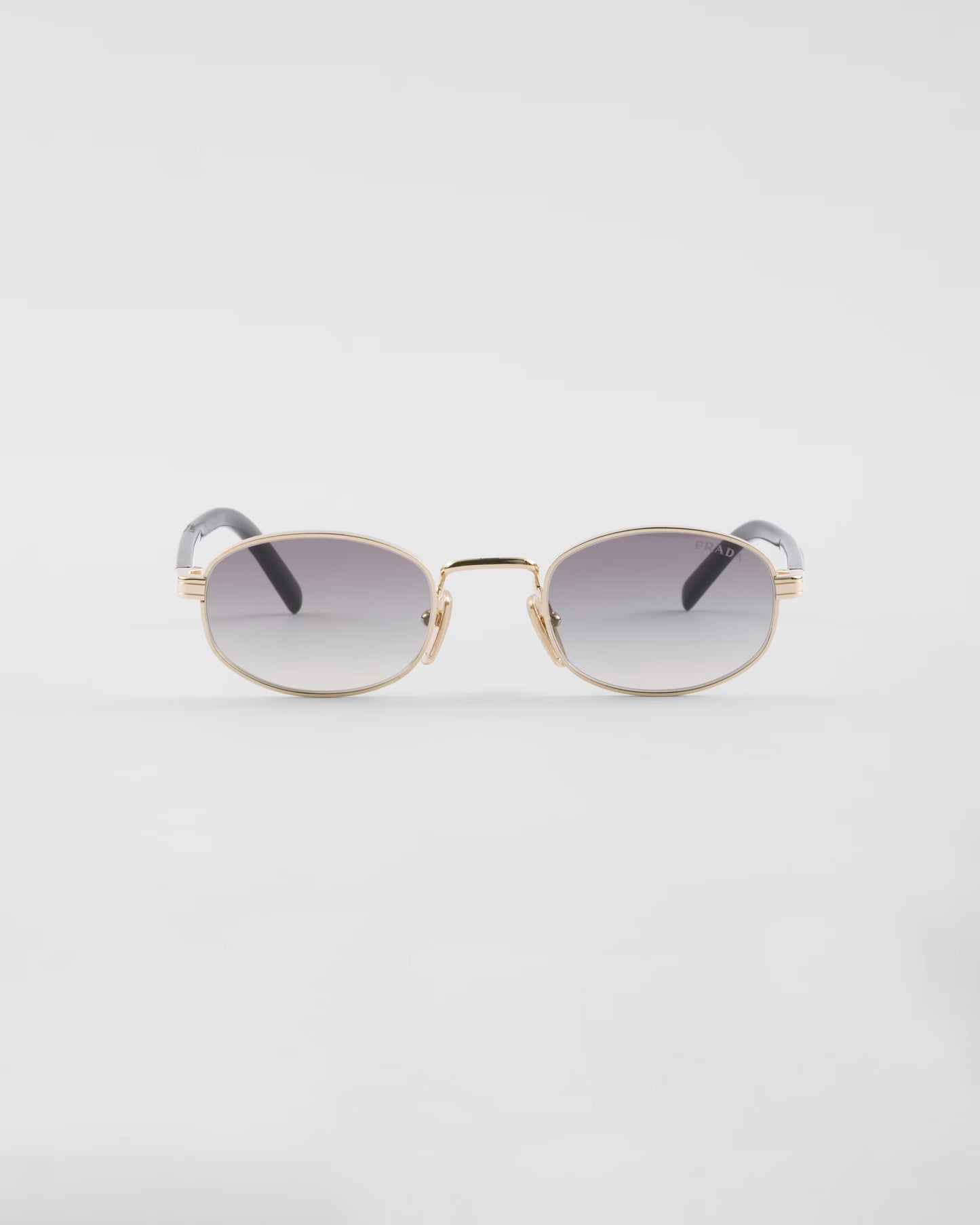 Prada PR B53 oval sunglasses in pale gold, front product view — The Quiet Edition