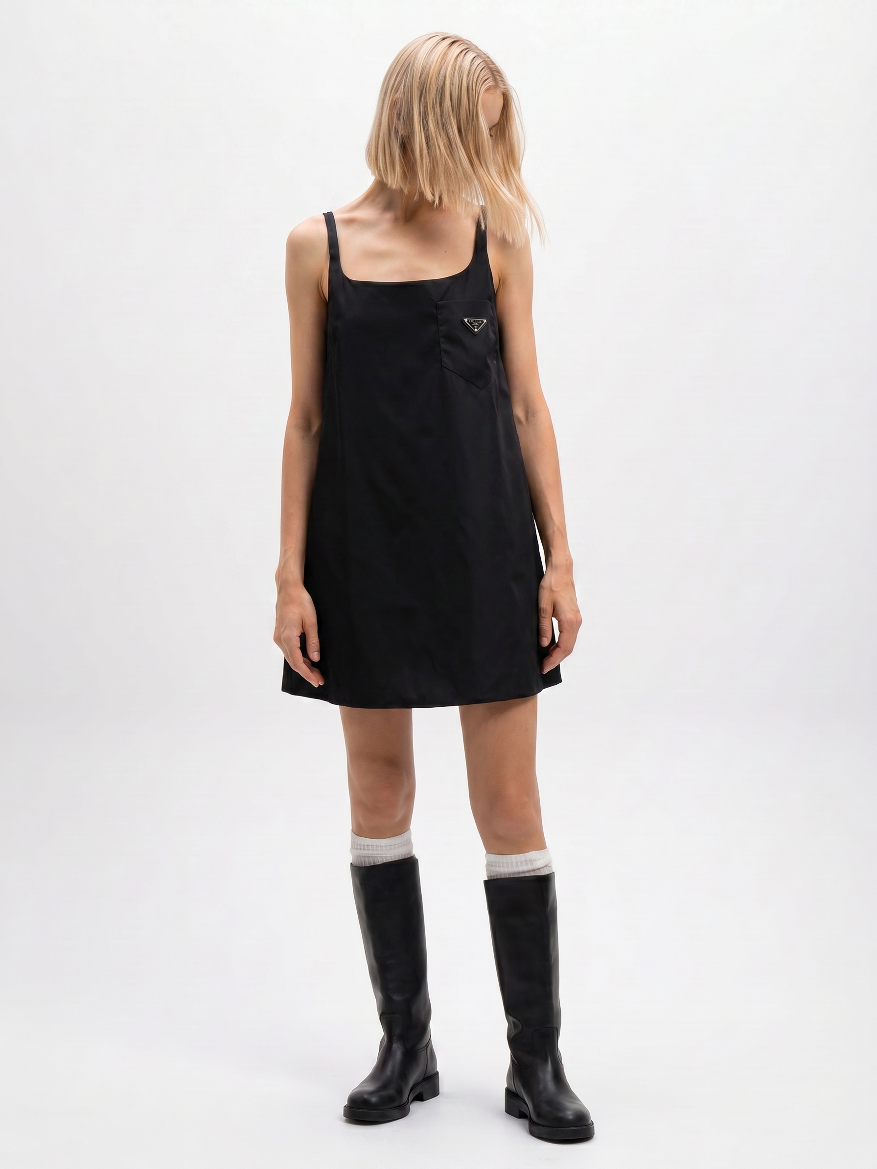 Prada Re-Nylon sleeveless dress in black, side view on model — The Quiet Edition