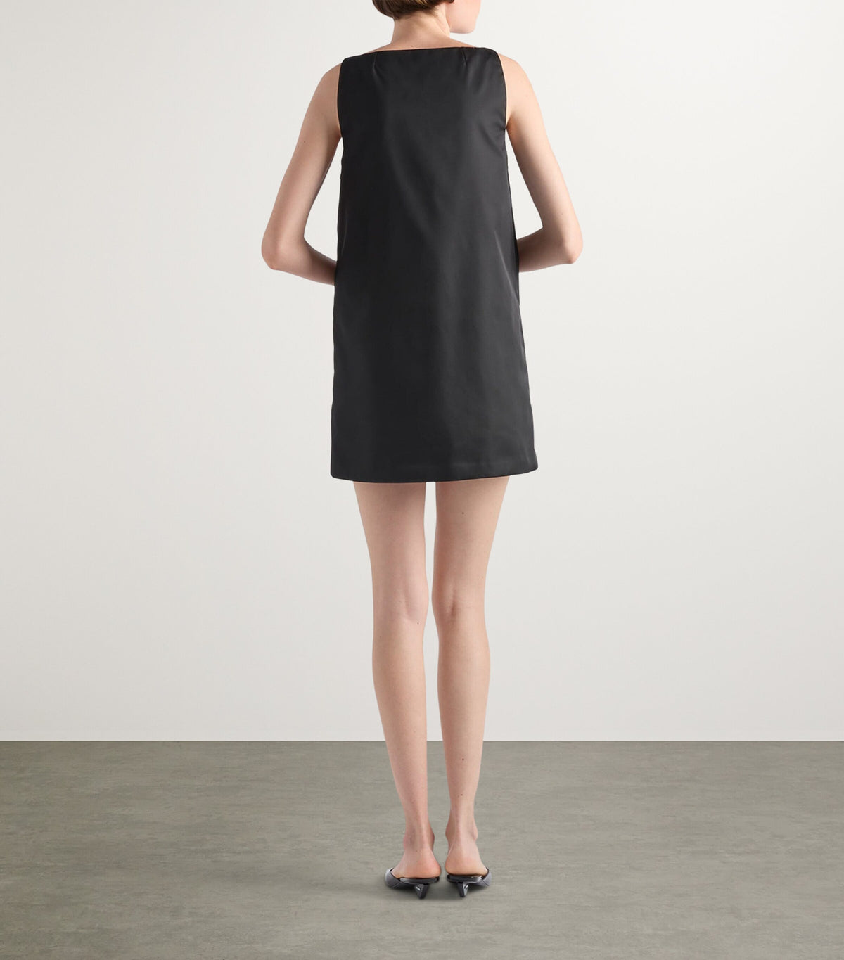 Prada Re-Nylon Buckle-Detail Mini Dress in Black, worn back view — The Quiet Edition