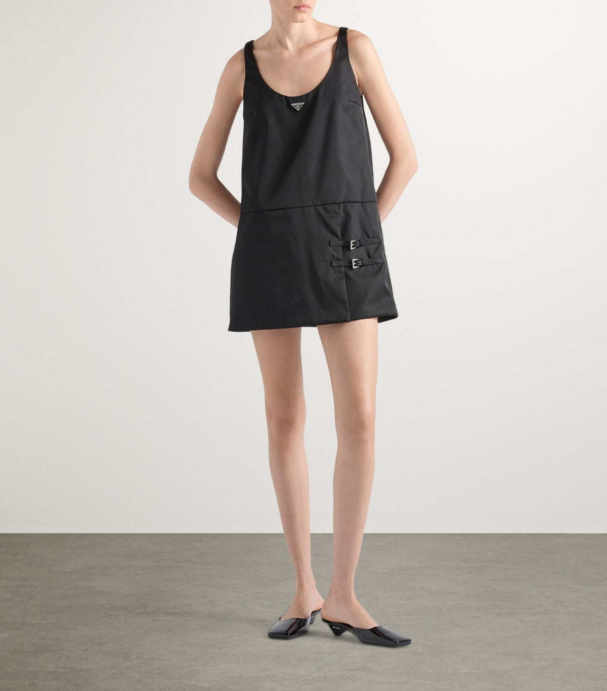 Prada Re-Nylon Buckle-Detail Mini Dress in Black, worn front view — The Quiet Edition