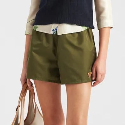Prada Re-Nylon shorts in olive, front view on model — The Quiet Edition