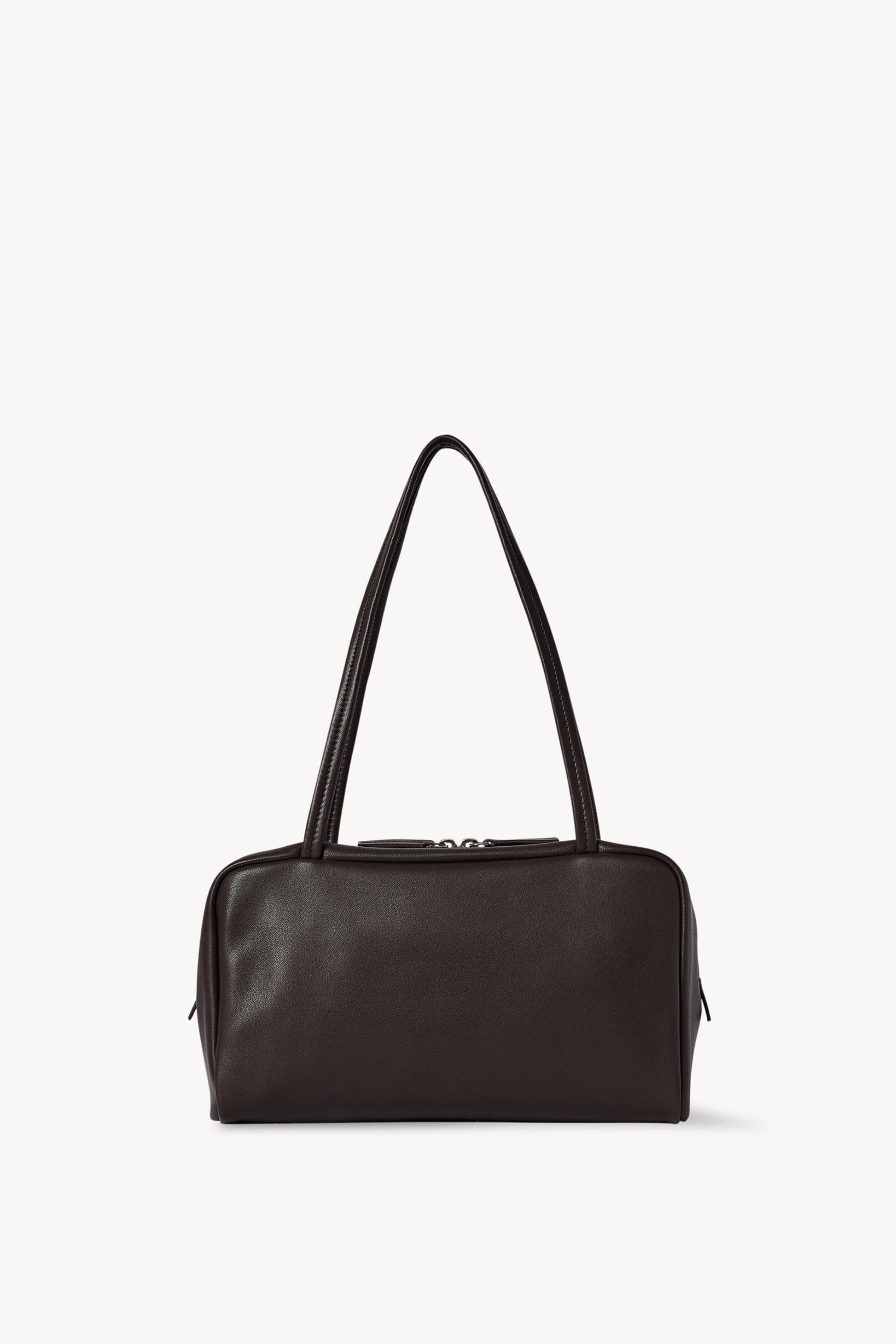 The Row Astra Bag in dark brown, front view of the soft nappa lambskin bowling silhouette