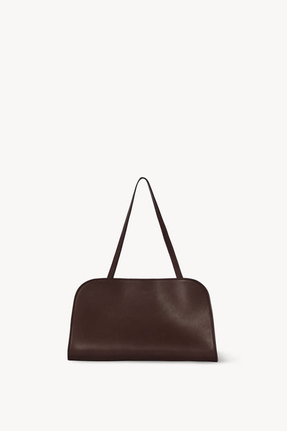 The Row Peggy Clutch in Burgundy, angle — The Quiet Edition
