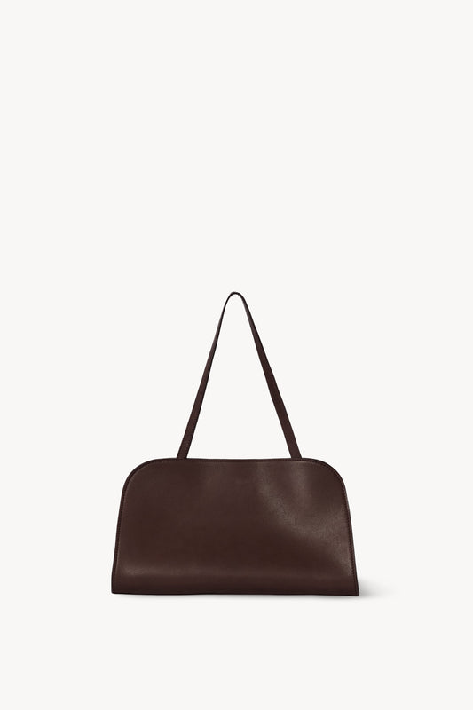 The Row Peggy Clutch in Burgundy, angle — The Quiet Edition