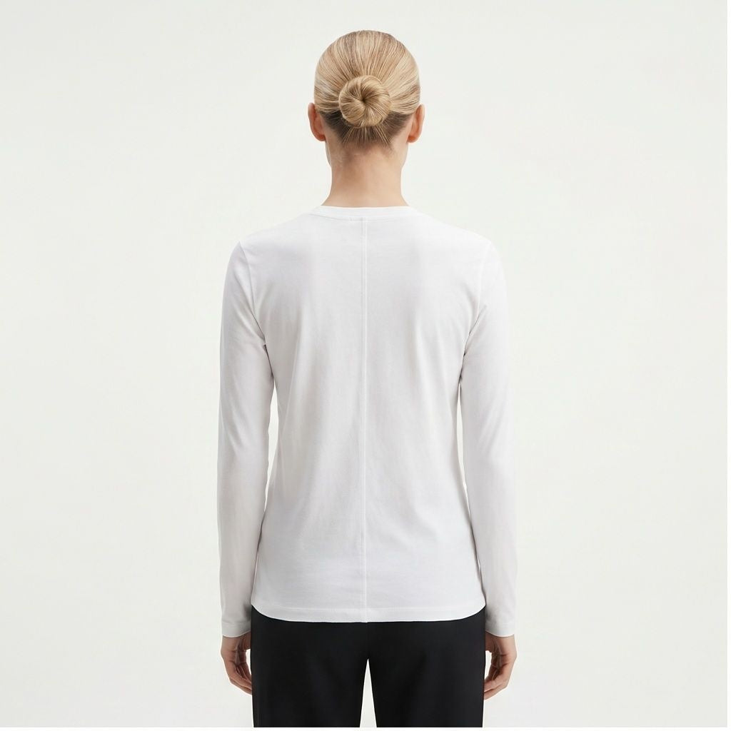 The Row Sherman long-sleeve t-shirt in white, back view on model — The Quiet Edition