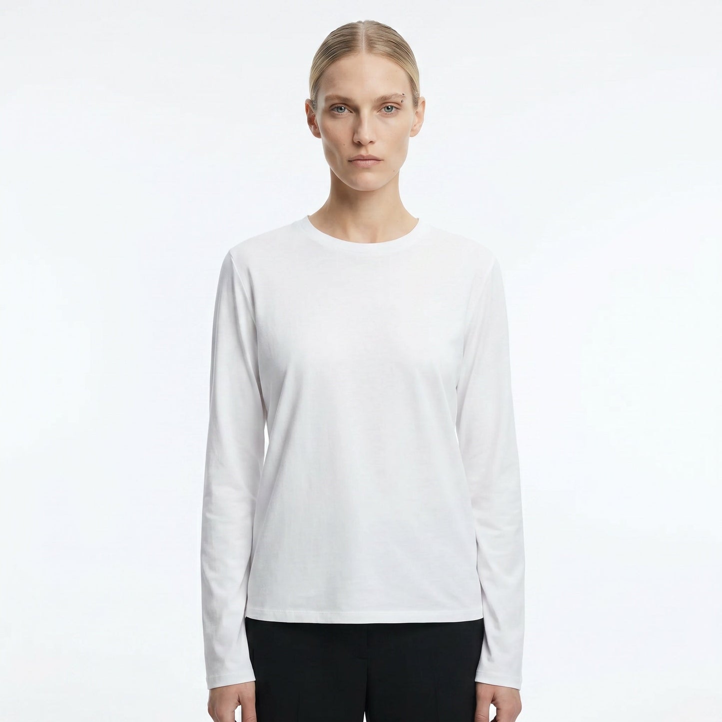 The Row Sherman long-sleeve t-shirt in white, front view on model — The Quiet Edition