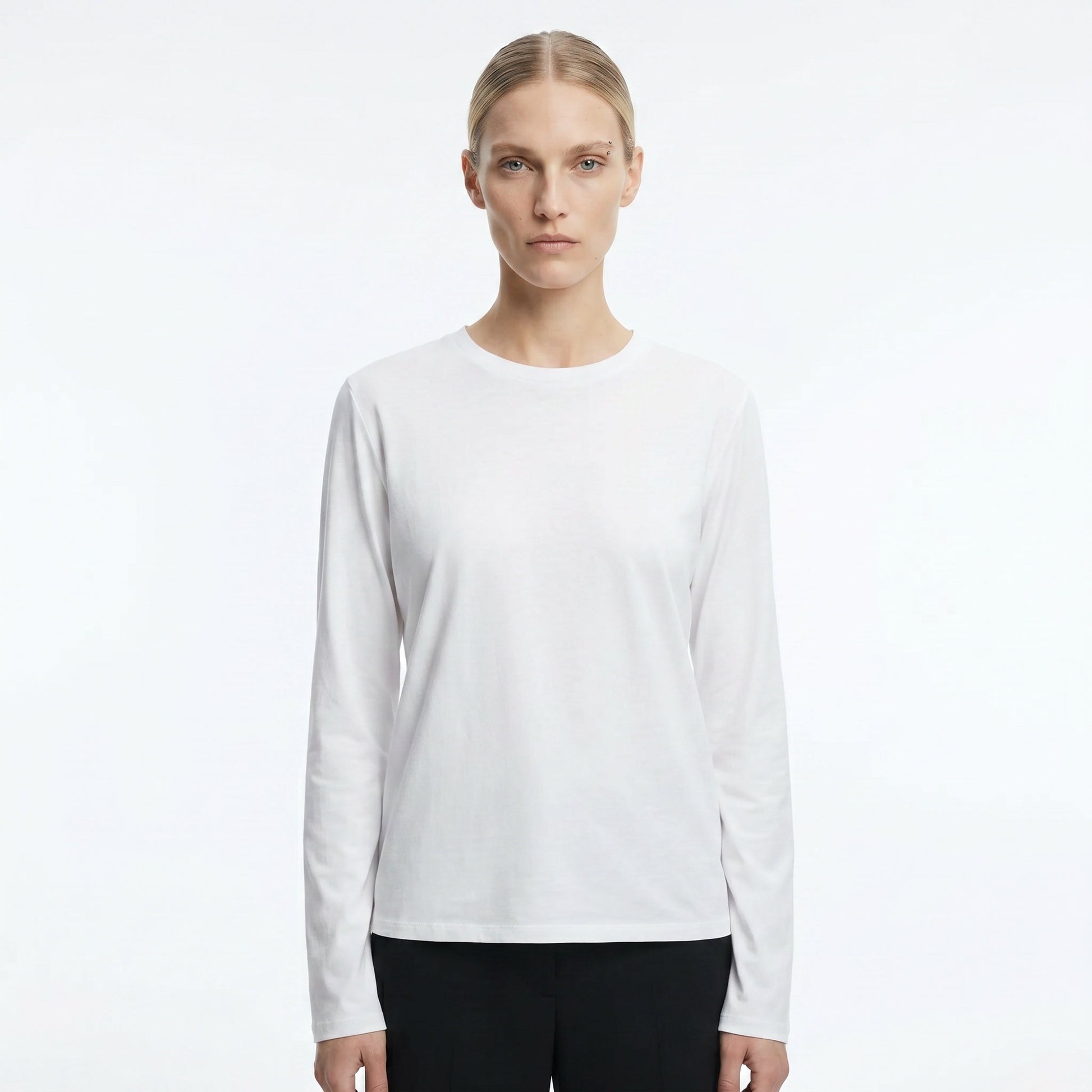 The Row Sherman long-sleeve t-shirt in white, front view on model — The Quiet Edition