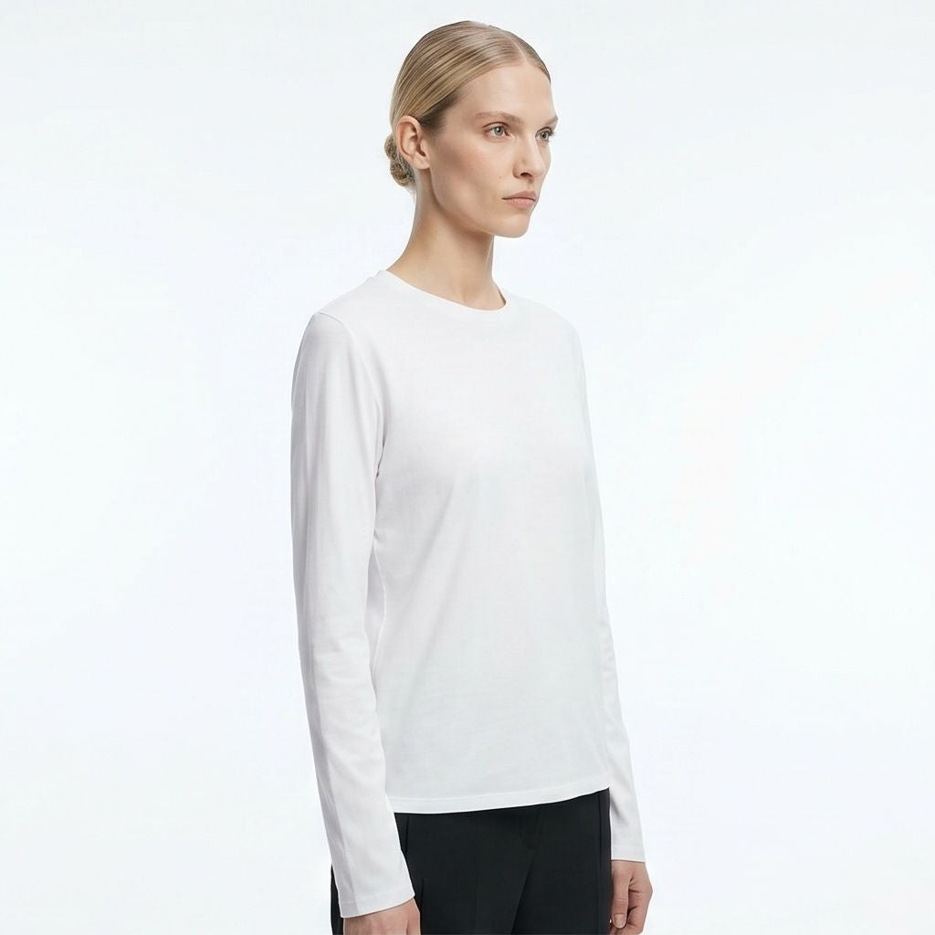 The Row Sherman long-sleeve t-shirt in white, side angle on model — The Quiet Edition