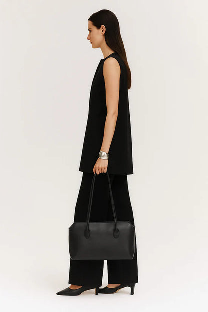 The Row Terrasse Leather Shoulder Bag in black, on model — The Quiet Edition