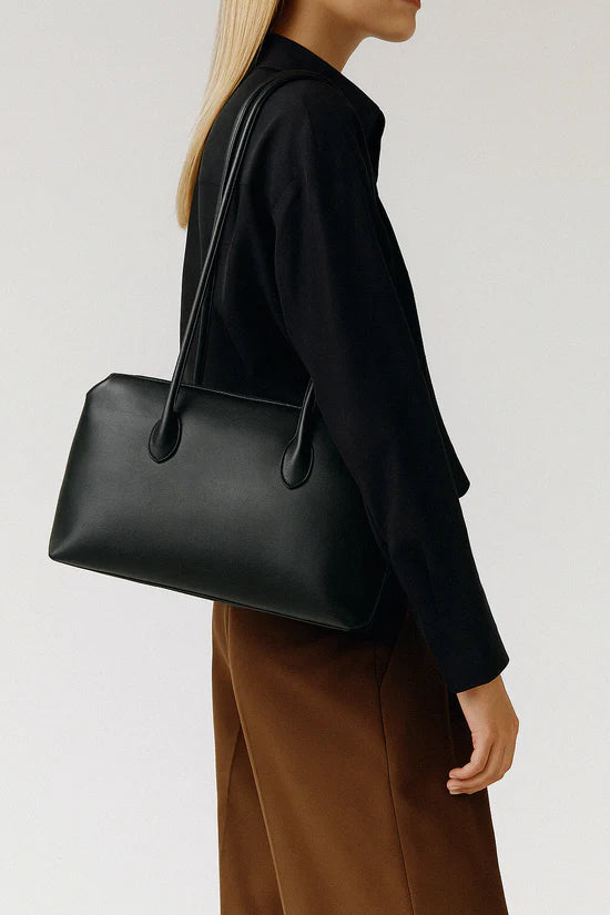 The Row Terrasse Leather Shoulder Bag in black, on model — The Quiet Edition