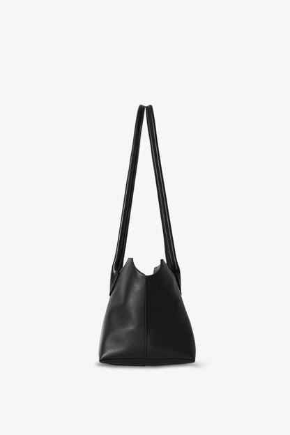 The Row Terrasse leather shoulder bag in black, side profile view — The Quiet Edition