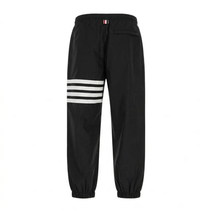 Thom Browne 4-Bar track pants in black, back view — The Quiet Edition