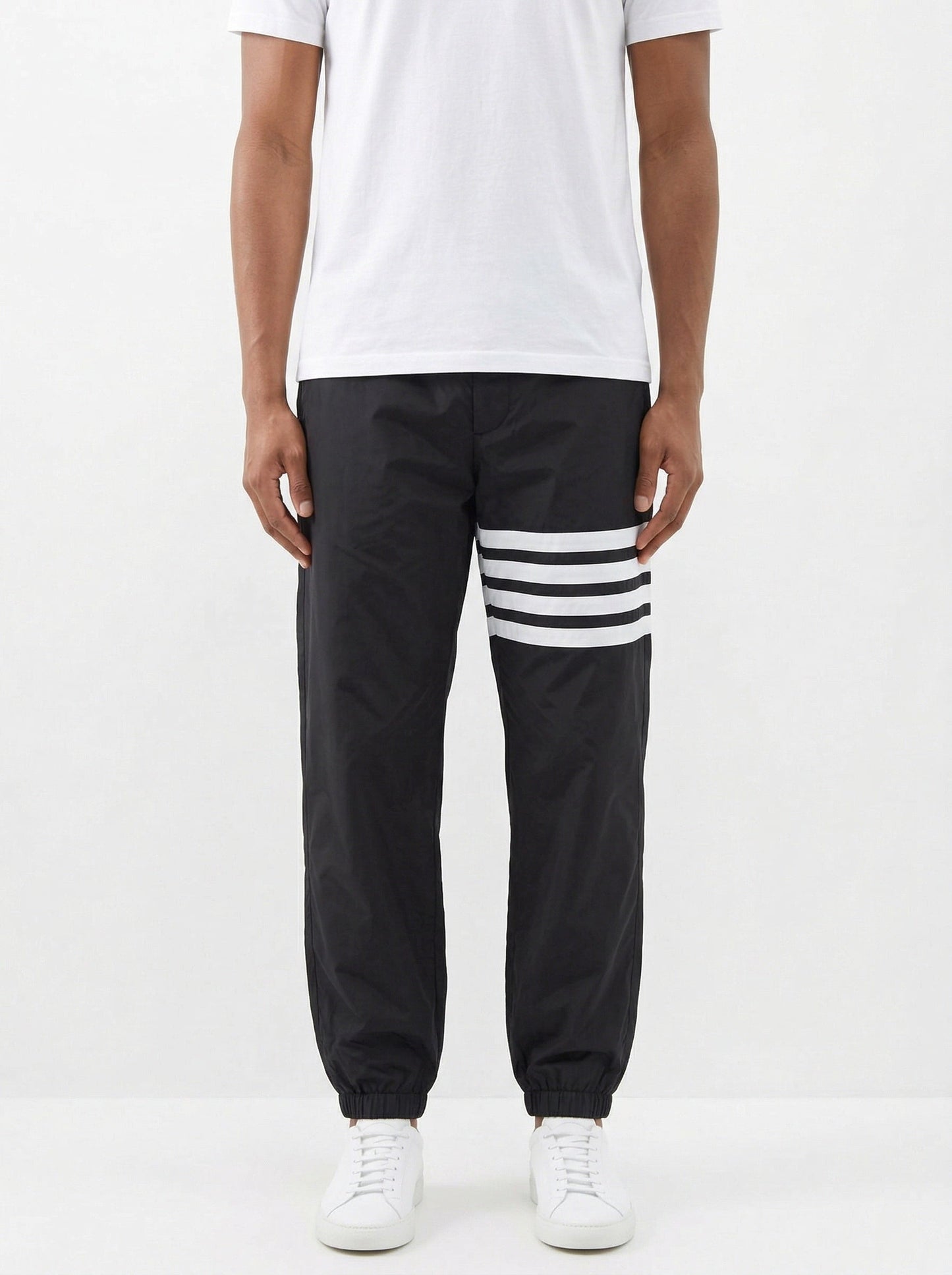 Thom Browne 4-Bar track pants in black, model front — The Quiet Edition