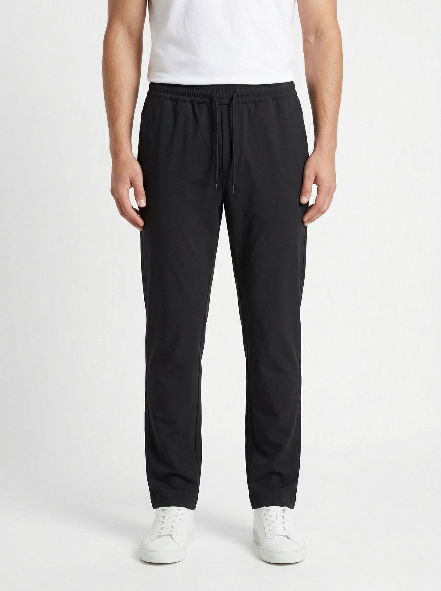 Zegna drawstring tapered trousers in black, model front — The Quiet Edition