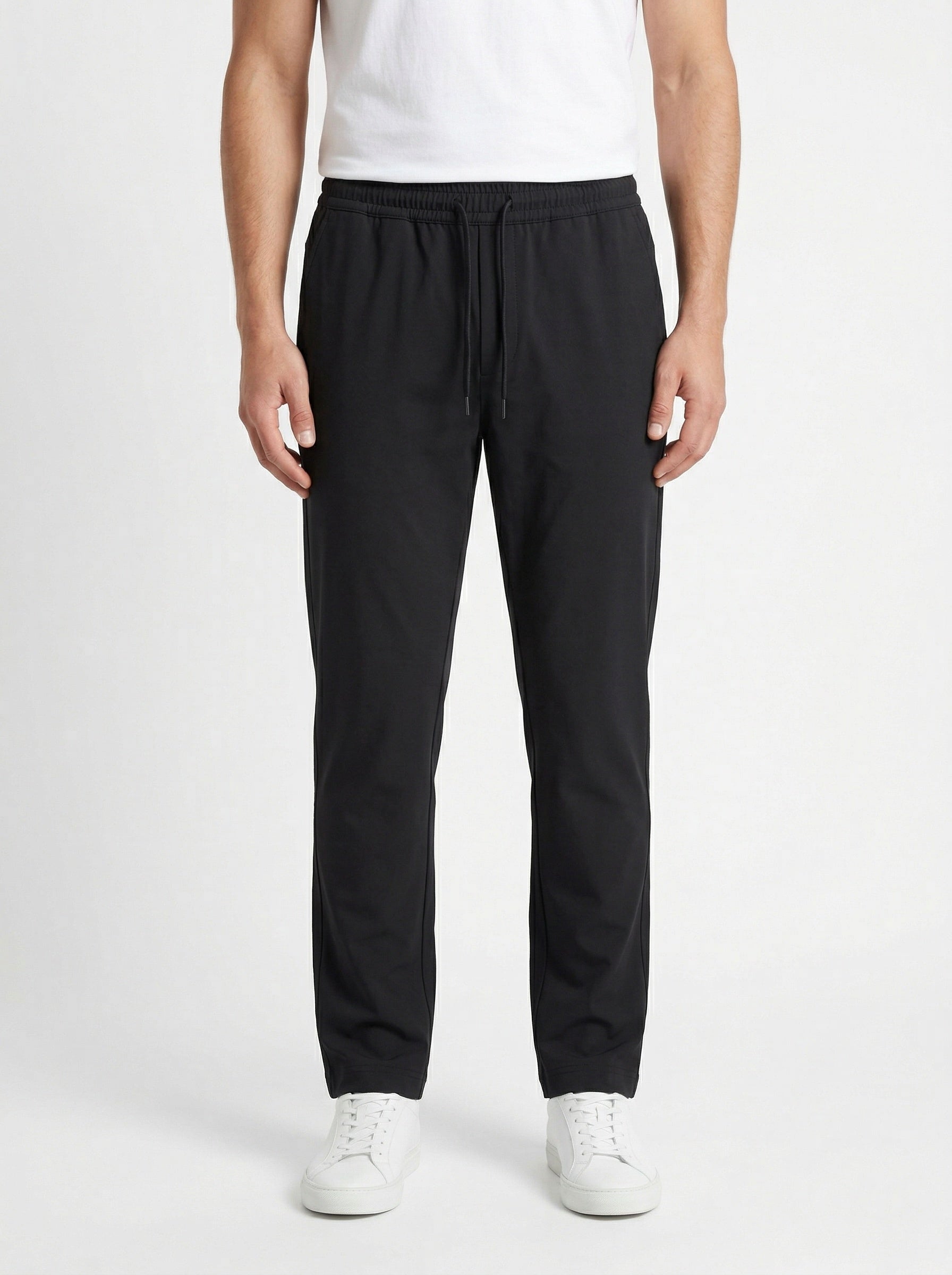 Zegna drawstring tapered trousers in black, model front — The Quiet Edition