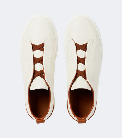 Zegna Triple Stitch leather sneakers in white, top-down view of the pair and tan leather lining