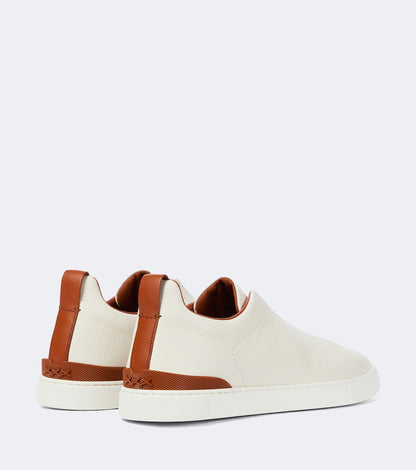 Zegna Triple Stitch leather sneakers in white, rear view with brown leather heel tabs