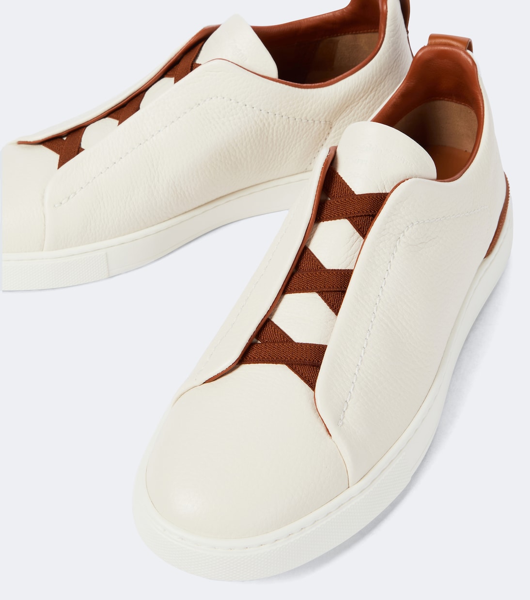Zegna Triple Stitch leather sneakers in white, close view of brown elasticated crossover laces